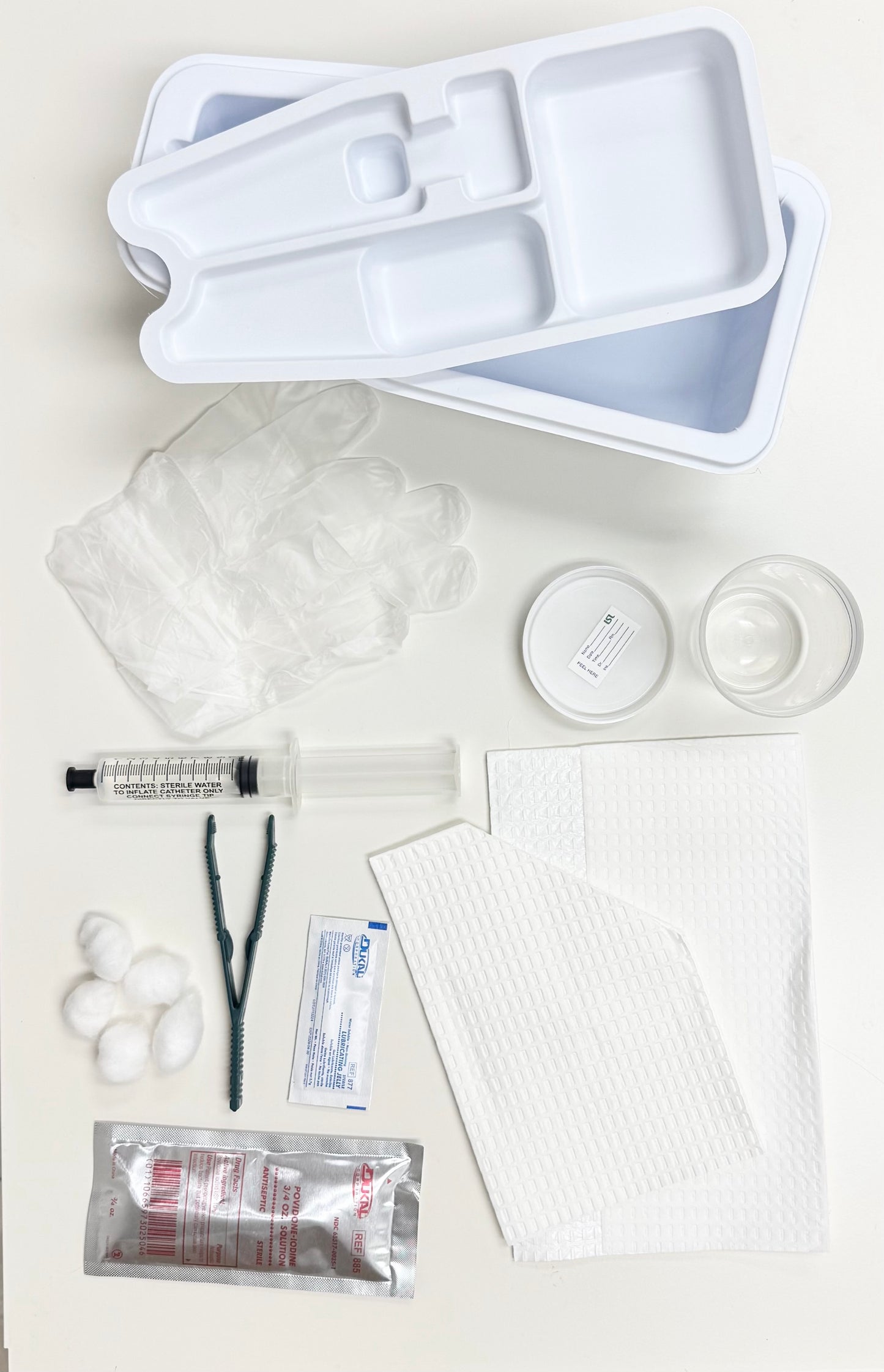LSL FOLEY CATHERIZATION TRAY WITHOUT CATHETER, 10 CC, PREP BALLS, PLASTIC FORCEPS, PVP SOLUTION, 10CC SYRINGE (pre-filled w/sterile water), WALLETED VINYL GLOVES MEDIUM, LUBRICATING JELLY, MOISTURE PROOF UNDER BUTTOCKS DRAPE, FENESTRATED DRAPE.