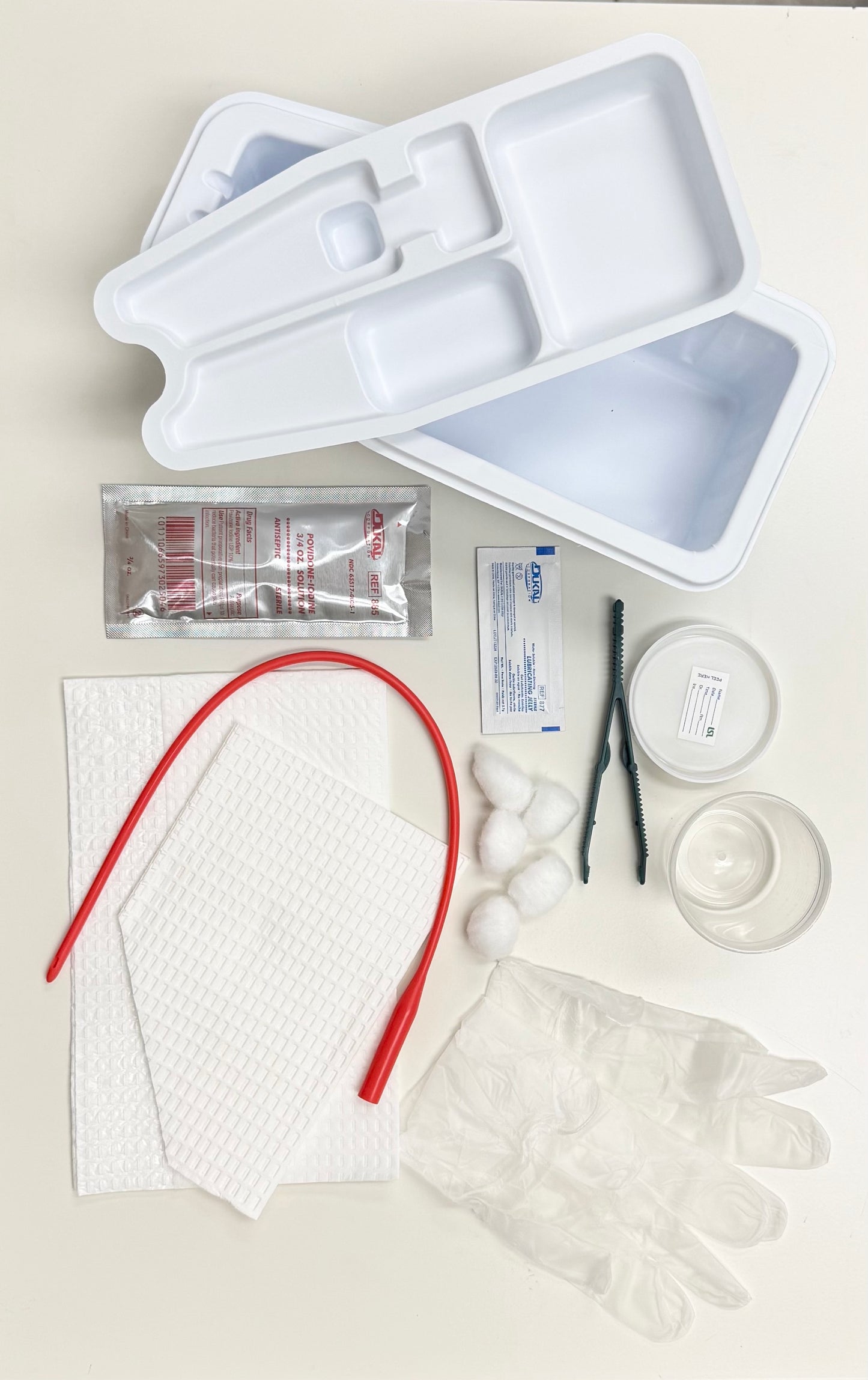 LSL URETHERAL CATHETERIZATION TRAY w/RED RUBBER CATHETER, PREP BALLS, PLASTIC FORCEPS, PVP SOLUTION, URETHRAL CATHETER, WALLETED VINYL GLOVES MEDIUM, LUBRICATING JELLY 2.7 GM, MOISTURE PROOF UNDER BUTTOCKS DRAPE, FENESTRATED DRAPE, SPECIMEN CONTAINER.